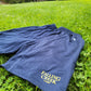 Navy athletic training shorts with side pockets and gold Falling Creek Camp Logo on left leg